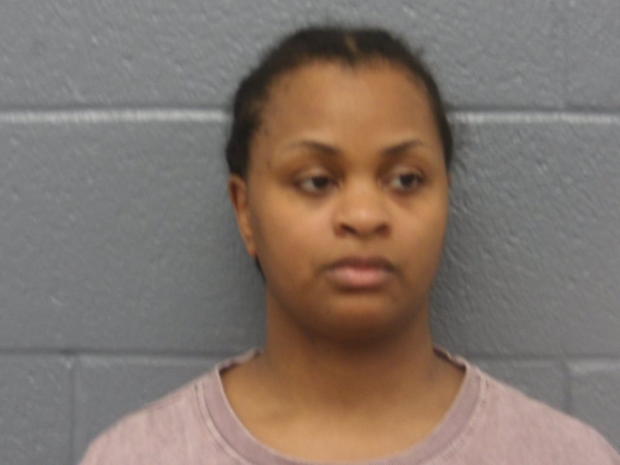 Woman charged with murder after girls found dead in suitcases