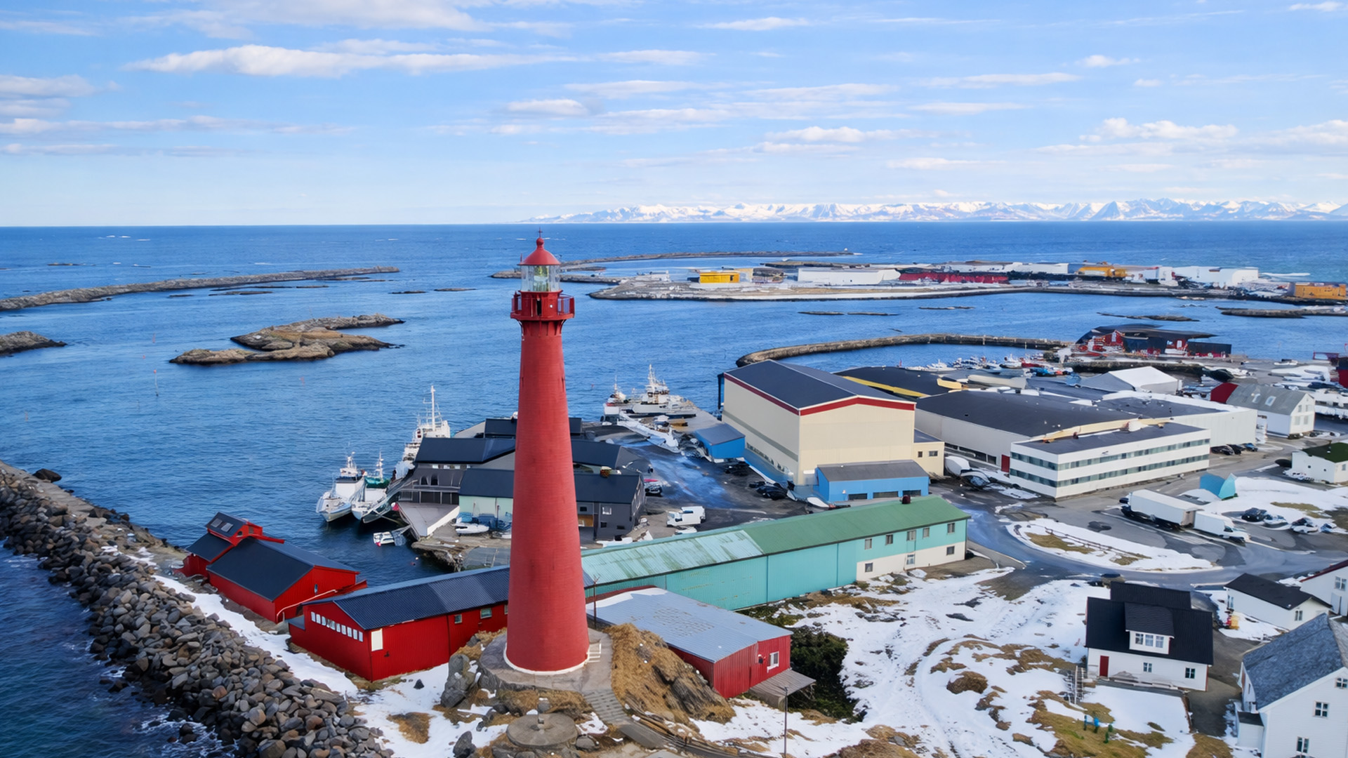 Arctic harbor with lighthouse and snowy mountains