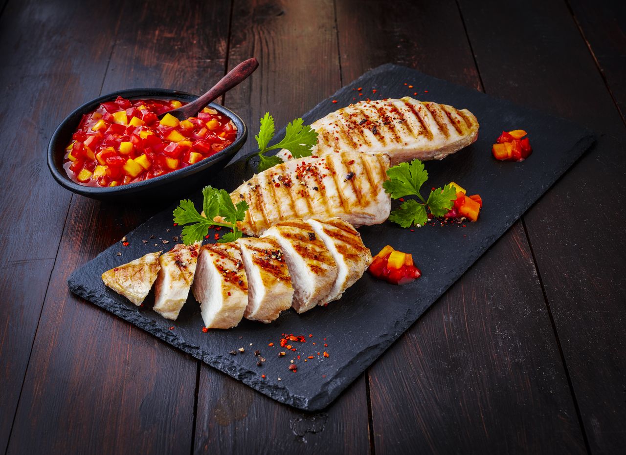 chicken breast sliced on a slab