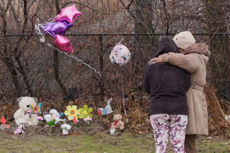 Woman arrested after the body of two young girls were found stuffed in ...