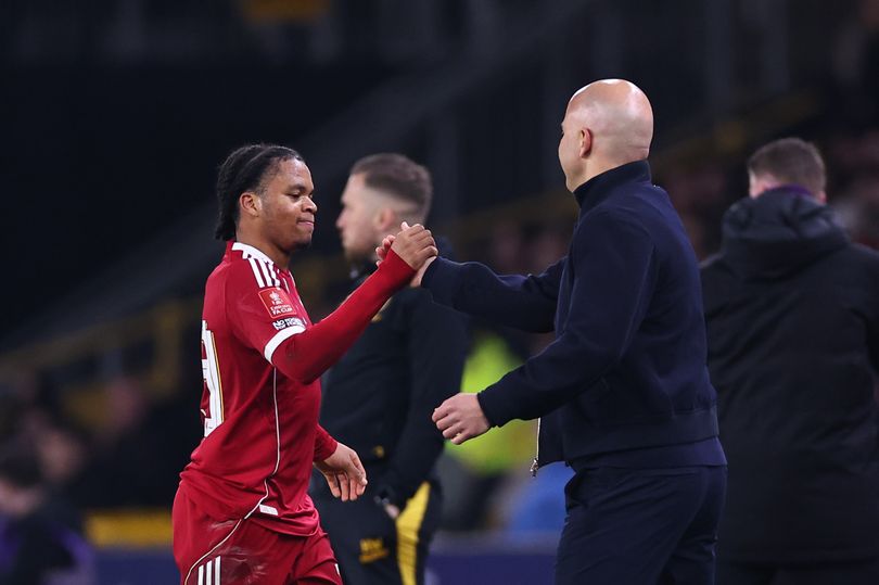 Liverpool winger Rio Ngumoha shakes hands with head coach Arne Slot.