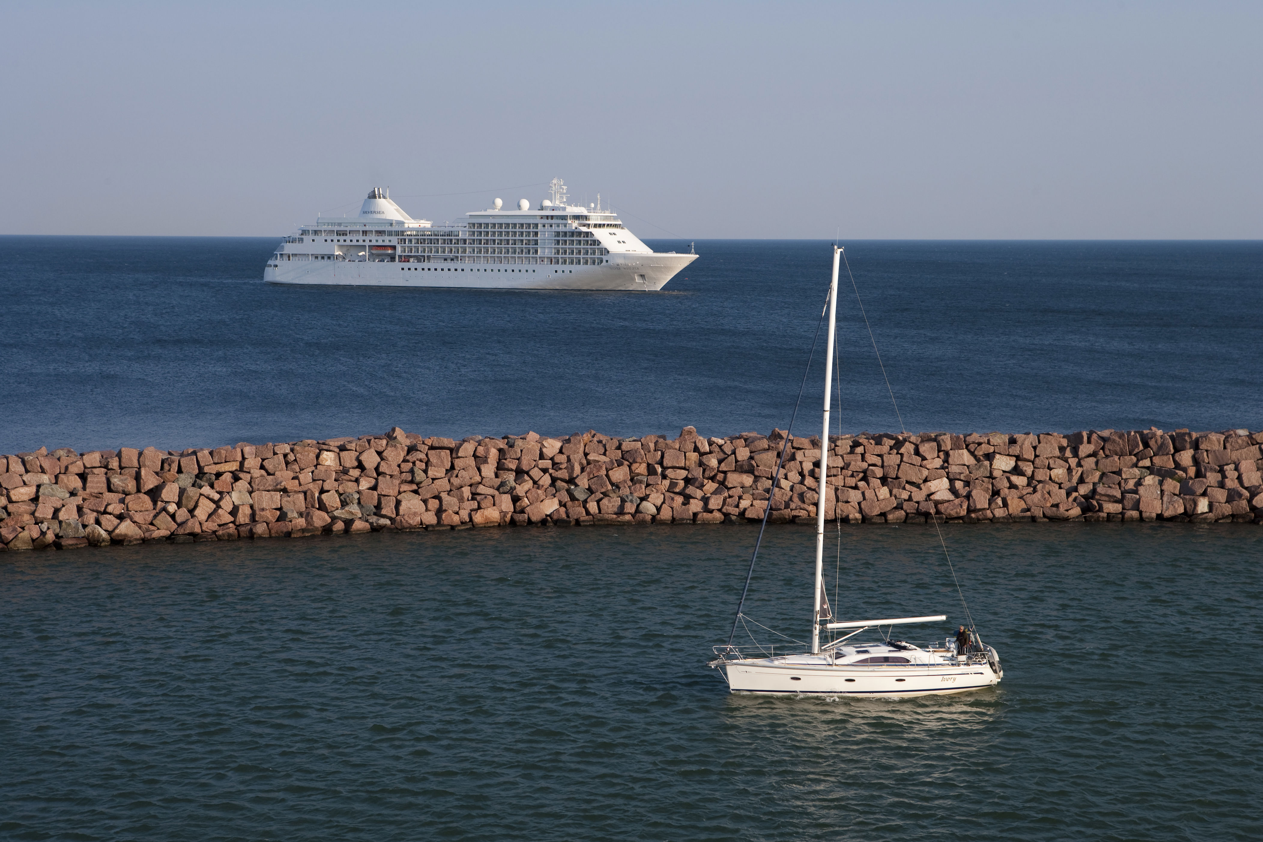 Sailboat and cruise ship Silver Whisper (Silversea Cruises).