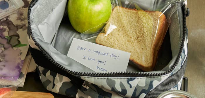 Lunchbox with apple and sandwich. Note reads, "Have a magical day! I love you! - Mom." To-do list includes feeding goblins and warding the house