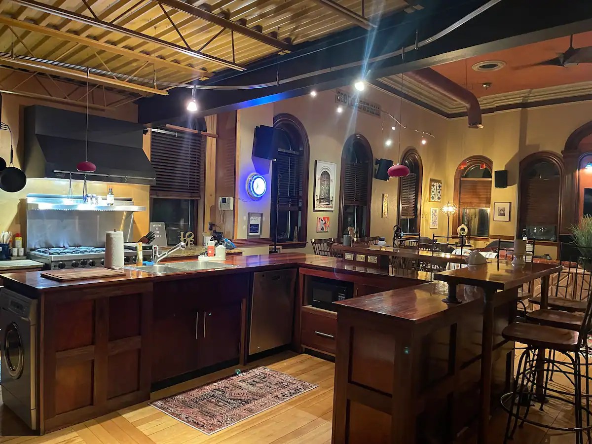 interior of a kitchen with dark wood and an open concept floor plan.