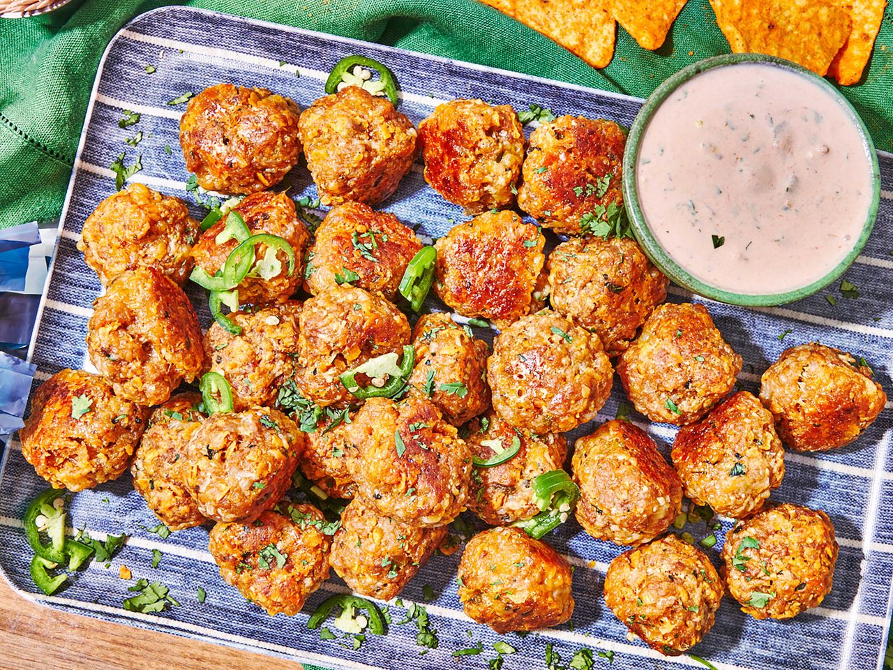 dorito sausage balls topped with jalapeno slices and served with sour cream-salsa dip
