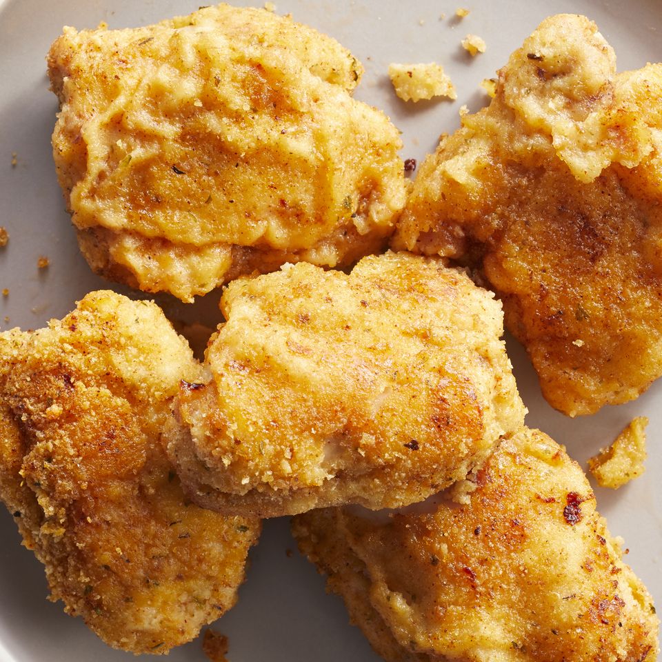 overhead angle looking down at a plate of golden brown oven fried chicken