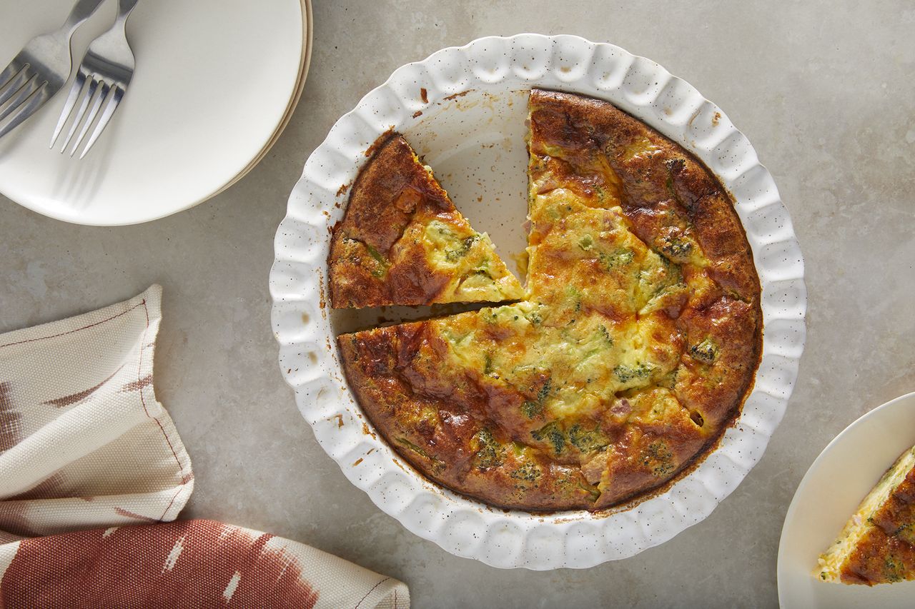 overhead view looking at a casserole dish of quiche with a slice cut