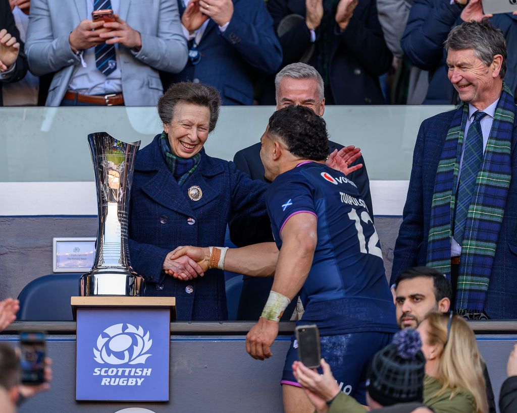 Princess Anne shows her cheeky side as she goes in for a hug during ...