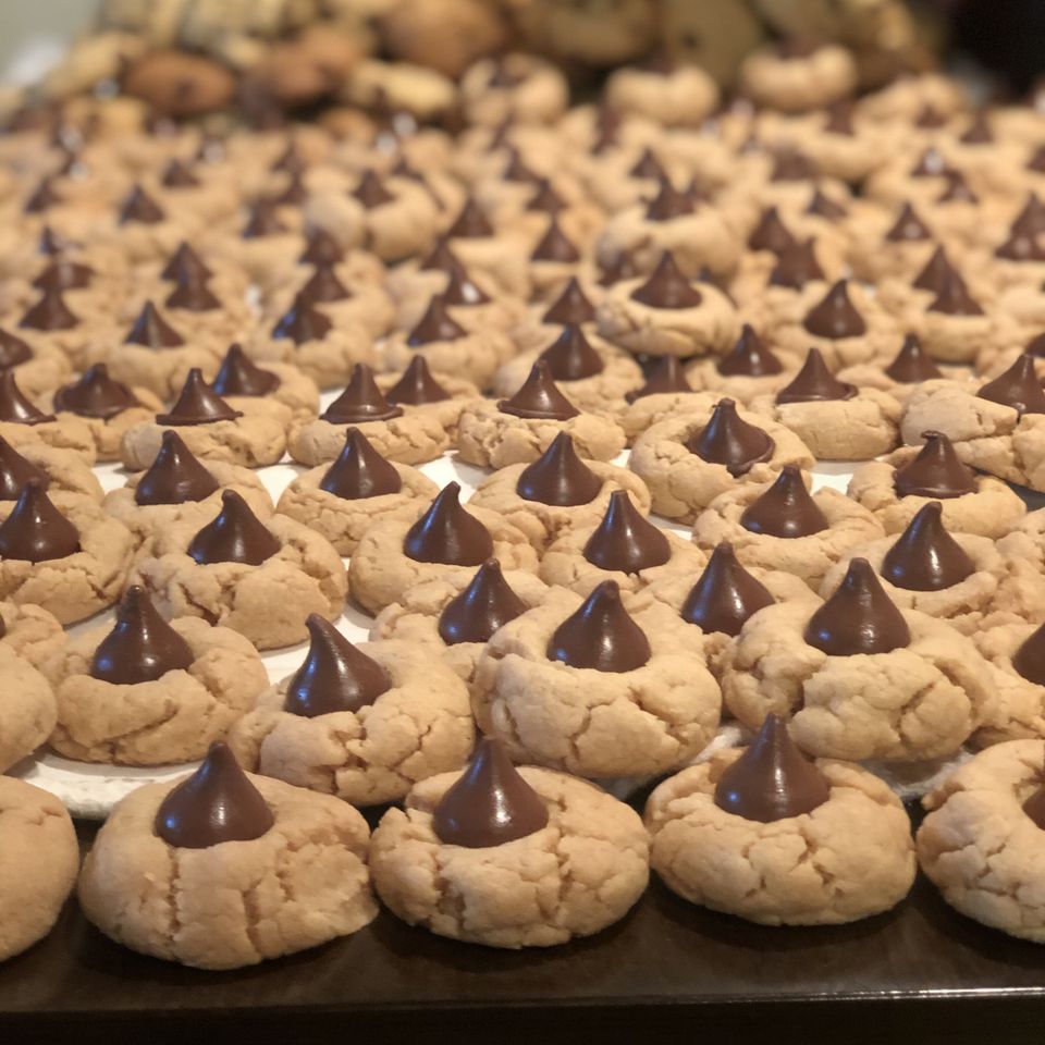 Peanut butter blossoms cookies rows of cookies with a chocolate drop in the center