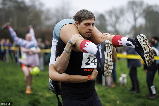 Couples take part in the UK's wife-carrying race on International Women ...