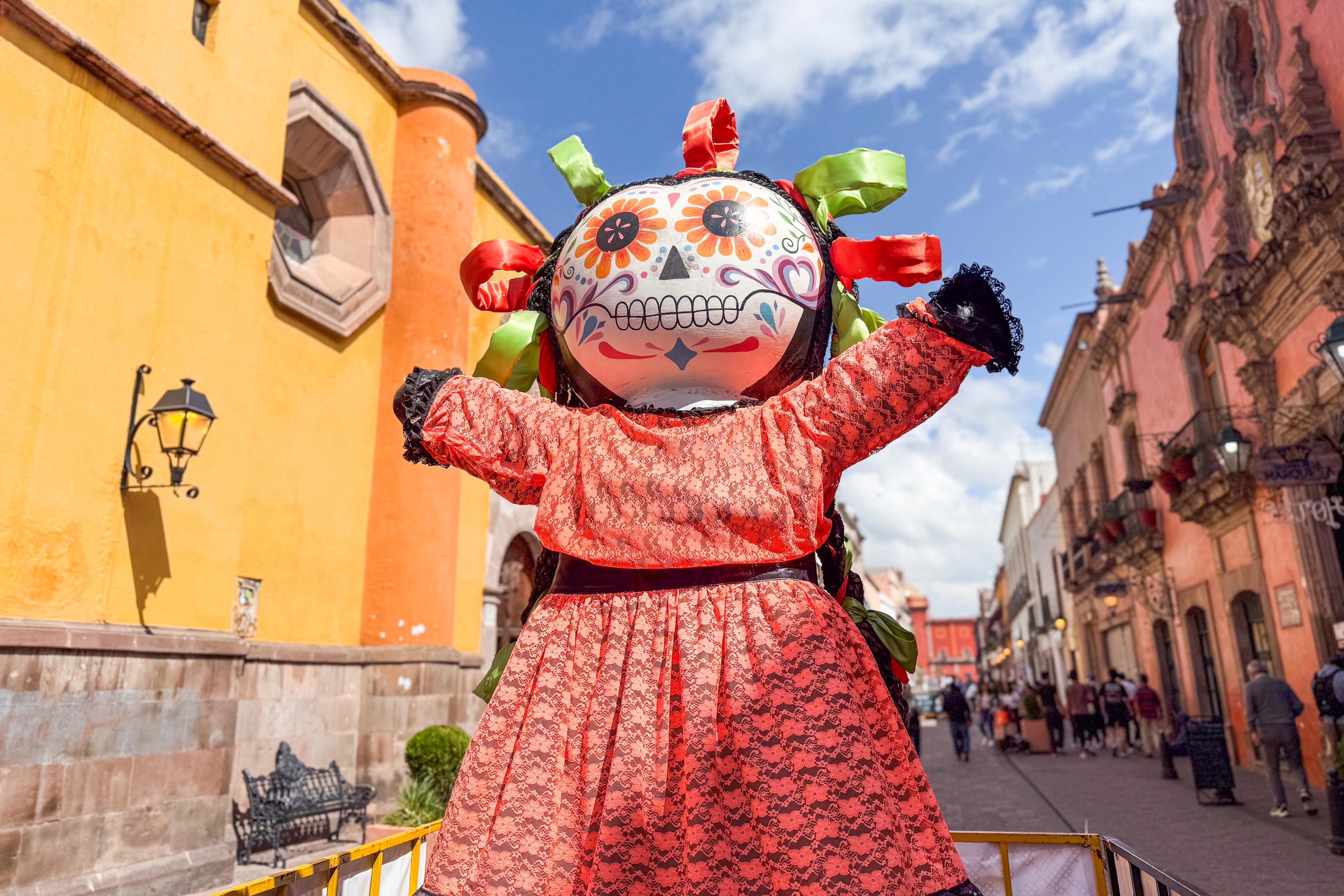 Figure with sugar skull head and colorful dress