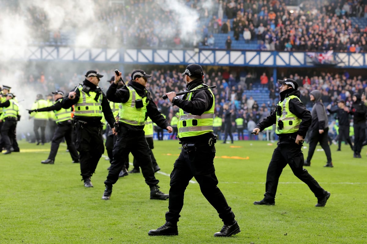 Rangers and Celtic fans invade pitch as chaos erupts after cup derby