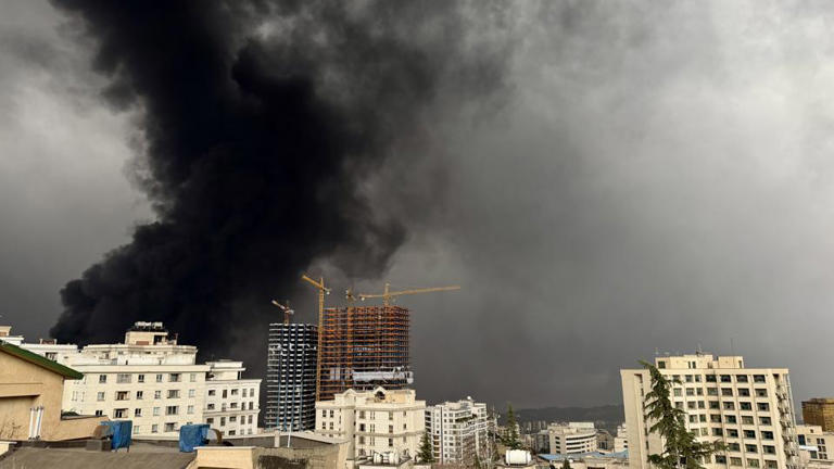 Black 'toxic' rain falls on Tehran after air strikes hit oil refineries