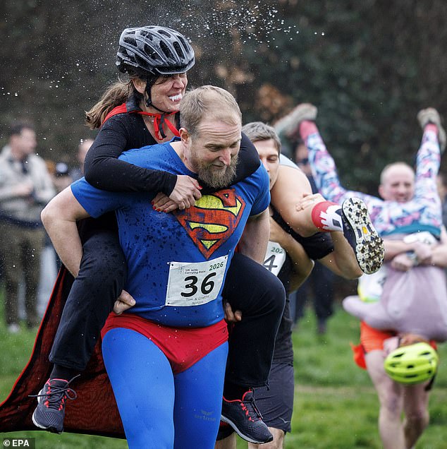 Couples take part in the UK's wife-carrying race on International Women ...