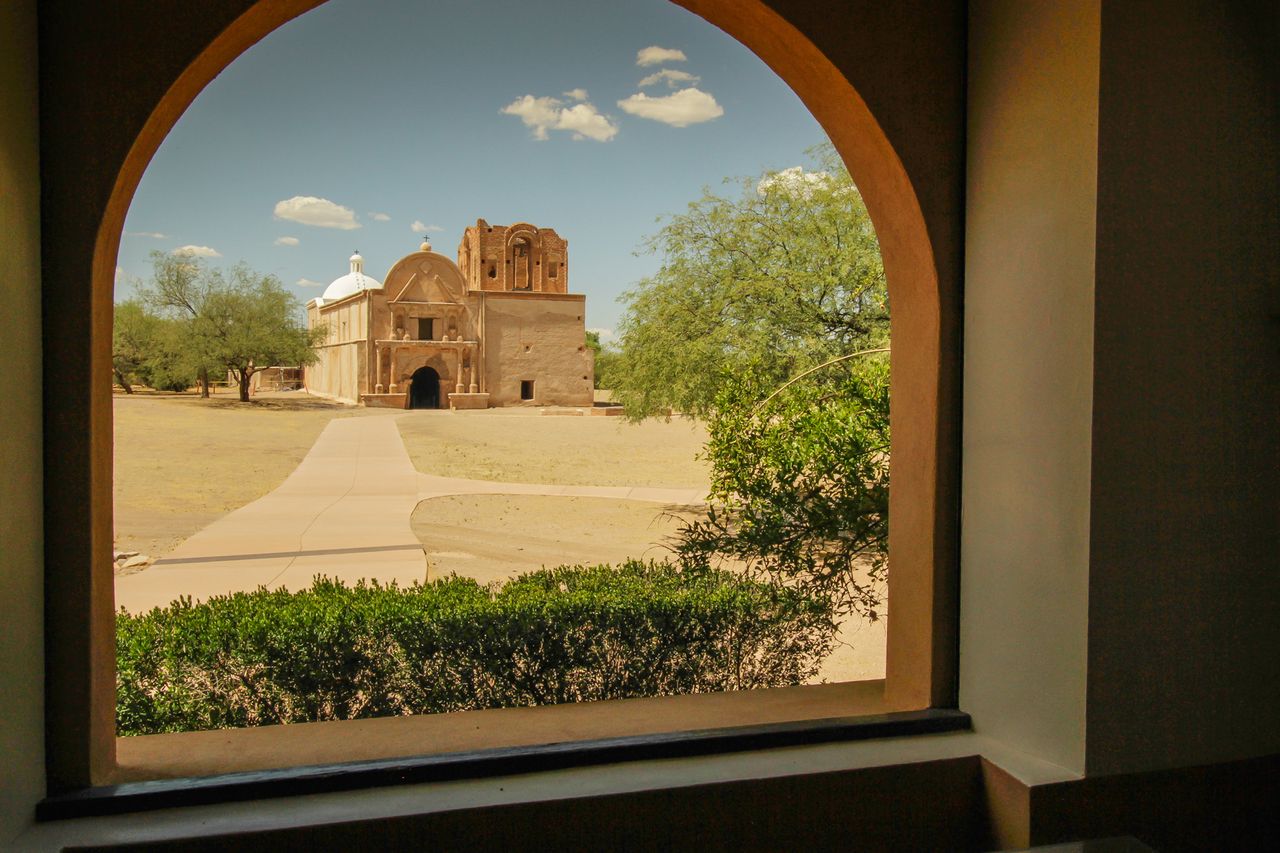 View of a historic mission church through an archway