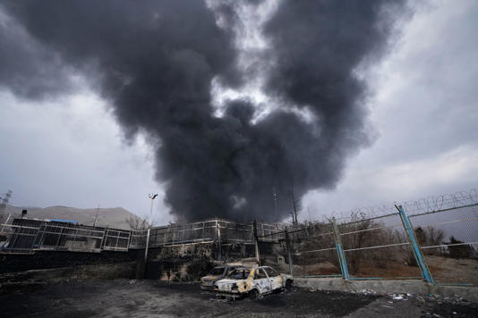 A thick plume of smoke rises from an oil storage facility hit by a U.S.-Israeli strike late Saturday in Tehran, Iran. (AP Photo/Vahid Salemi)