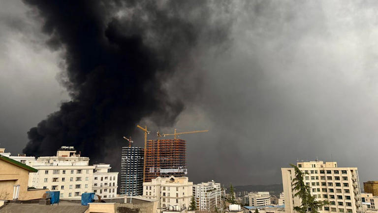 Black 'toxic' rain falls on Tehran after air strikes hit oil refineries
