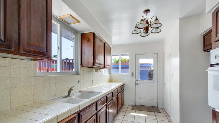 Elevate old kitchen cabinets with this easy paint hack