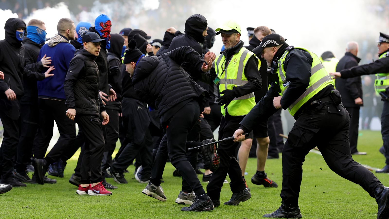 Rangers and Celtic fans in 'shameful' clashes on pitch after cup tie