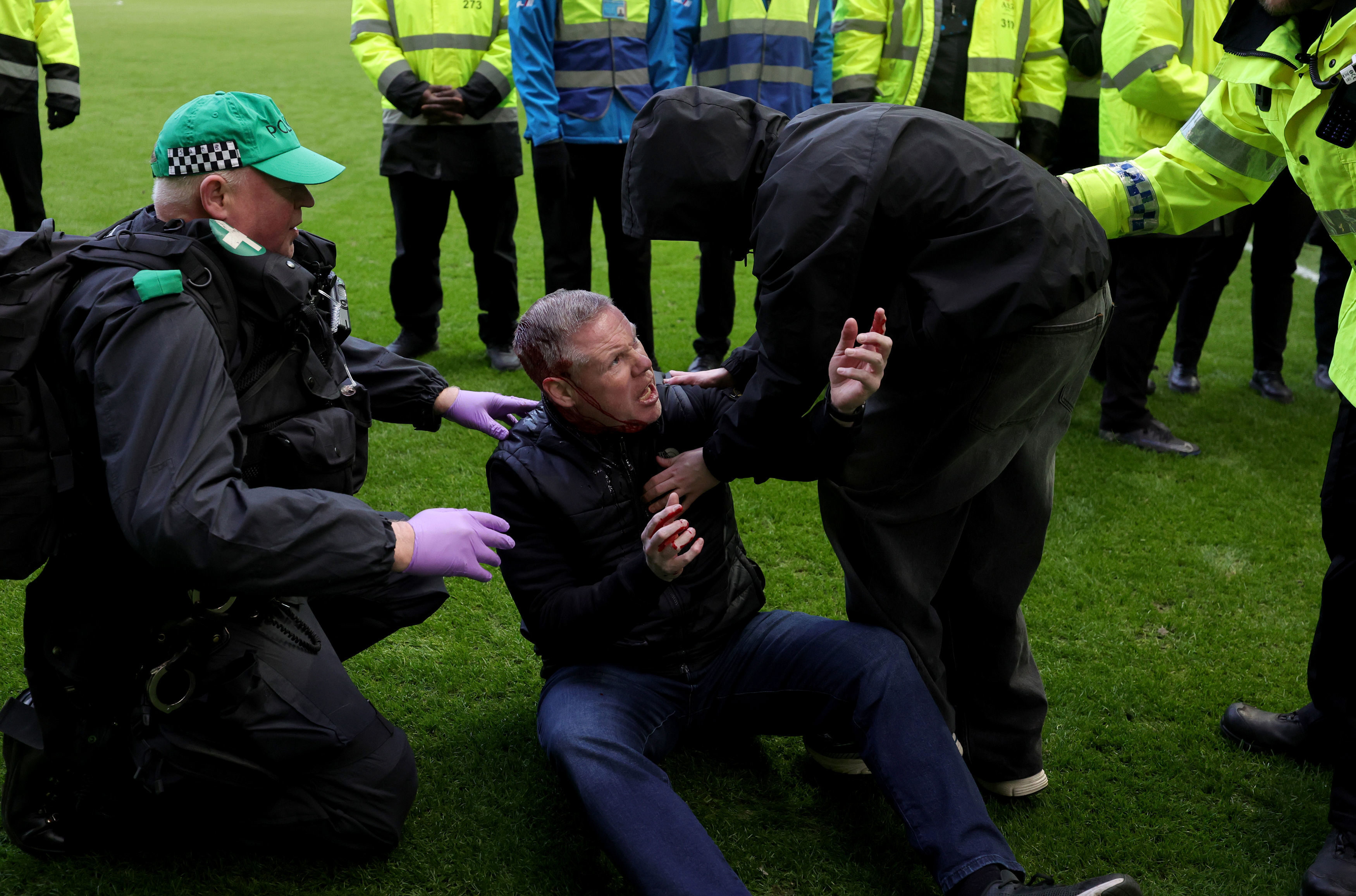 'Despicable' scenes as fans storm pitch, assault coach