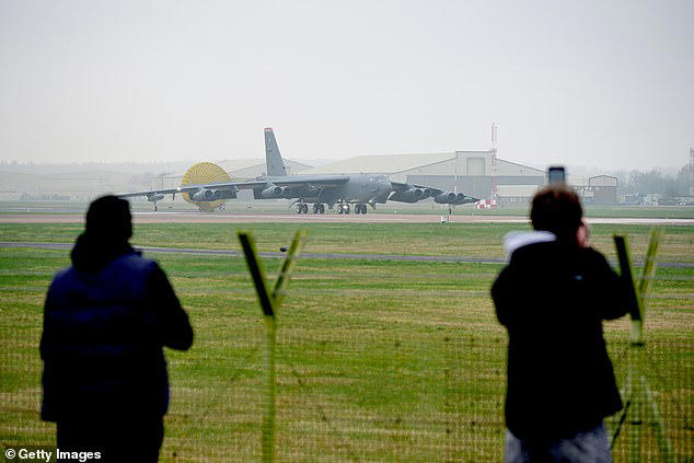 Onlookers stood at the perimeter fence as the Cold War-era aircraft capable of firing nuclear missiles arrived on the tarmac