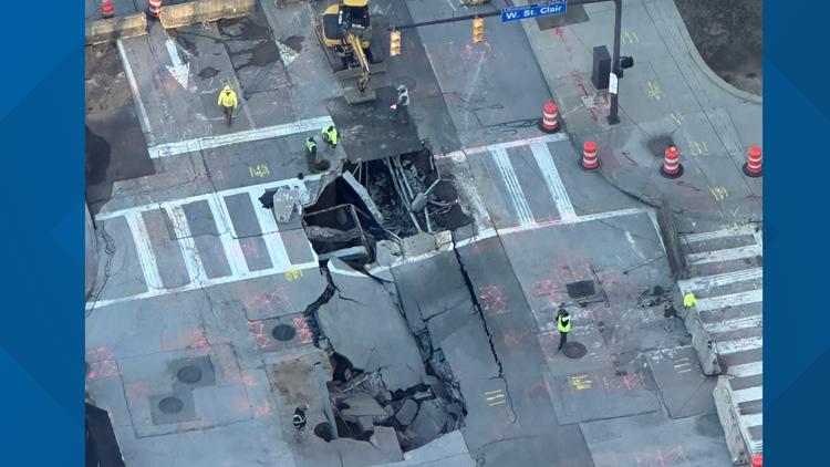 No injuries after car pulled from large sinkhole in downtown Cleveland ...