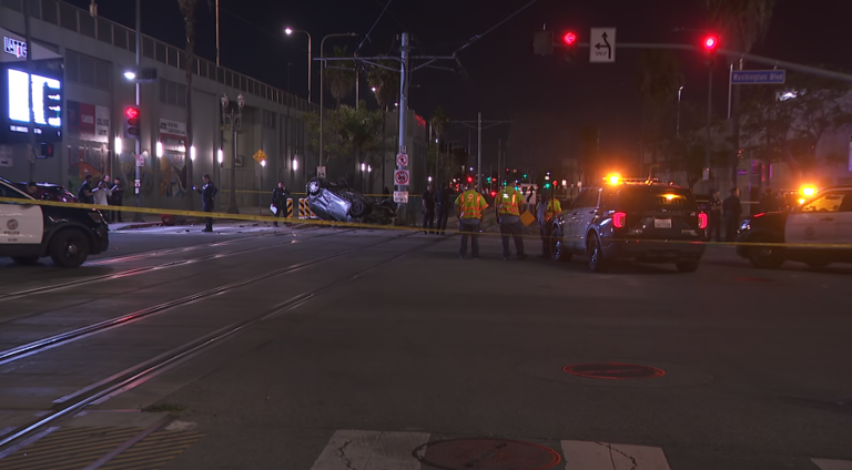 Woman dies in crash that left car on downtown LA train tracks