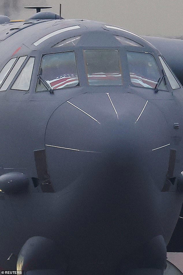 The American flag was seen draped in the cockpit of a B-52 Stratofortress nicknamed the 'Iron Butterly' as it landed on the runway