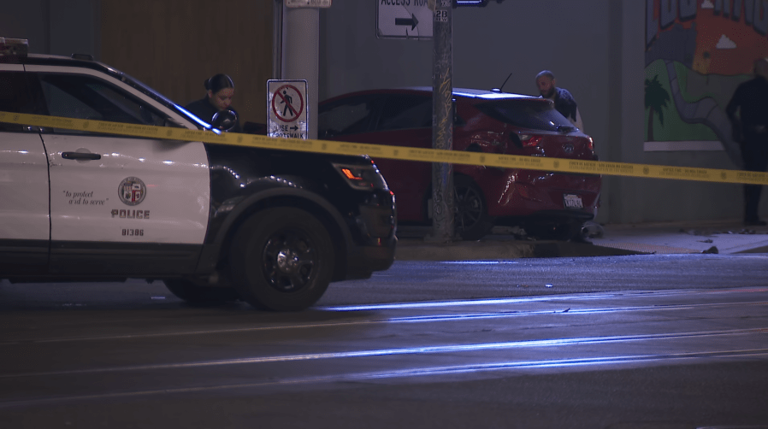 Woman dies in crash that left car on downtown LA train tracks