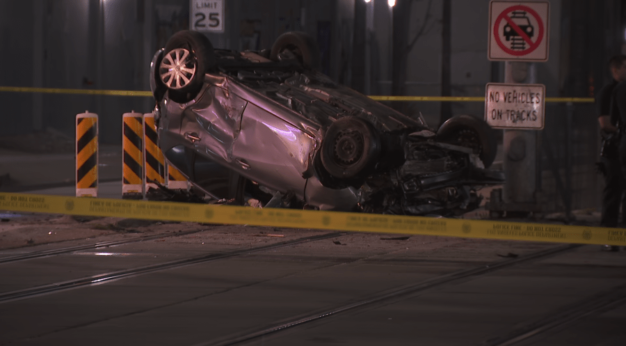 Woman dies in crash that left car on downtown LA train tracks