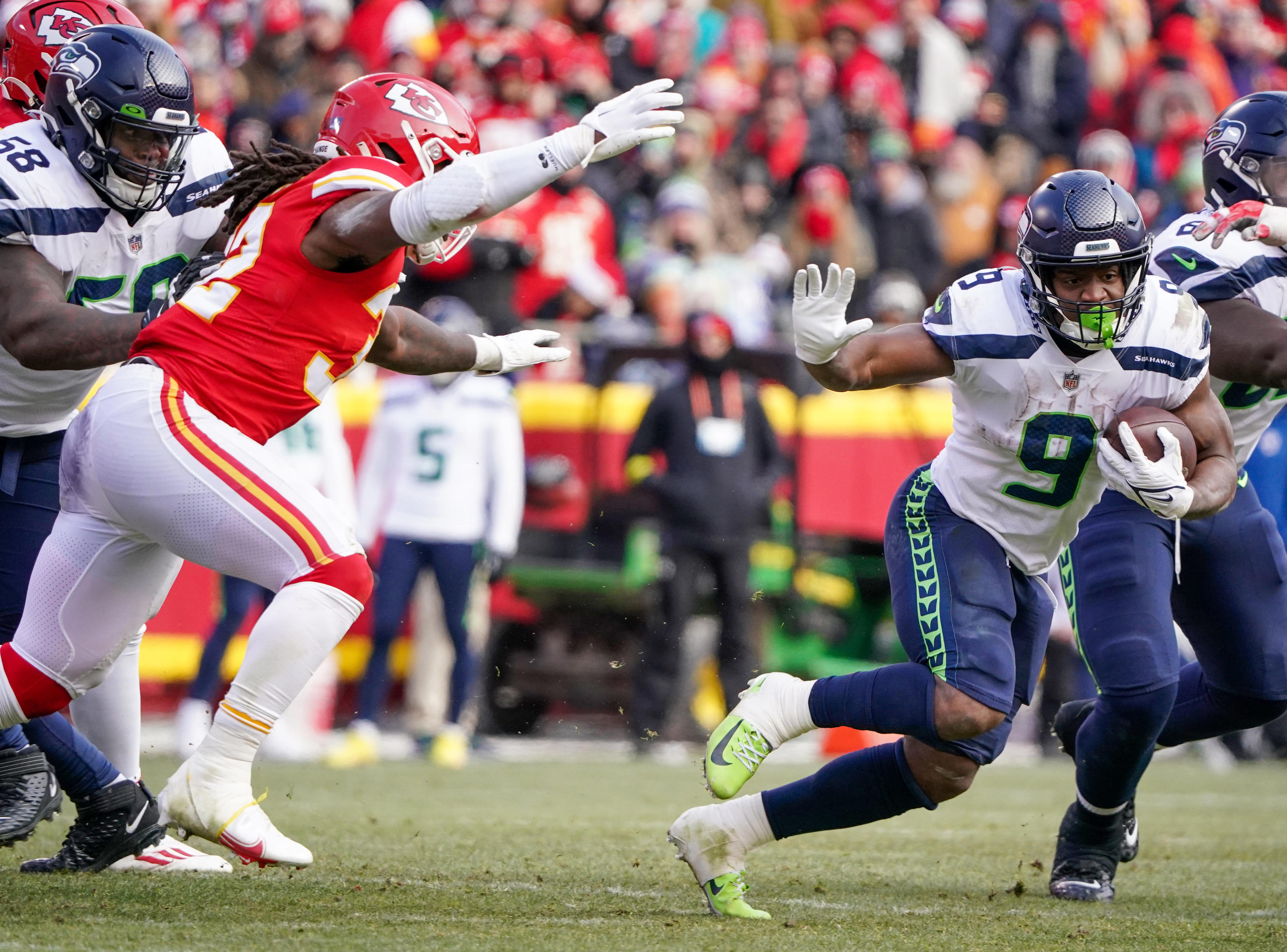 Dec 24, 2022; Kansas City, Missouri, USA; Seattle Seahawks running back Kenneth Walker III (9) runs the ball as Kansas City Chiefs linebacker Nick Bolton (32) defends during the second half at GEHA Field at Arrowhead Stadium. Mandatory Credit: Denny Medley-USA TODAY Sports