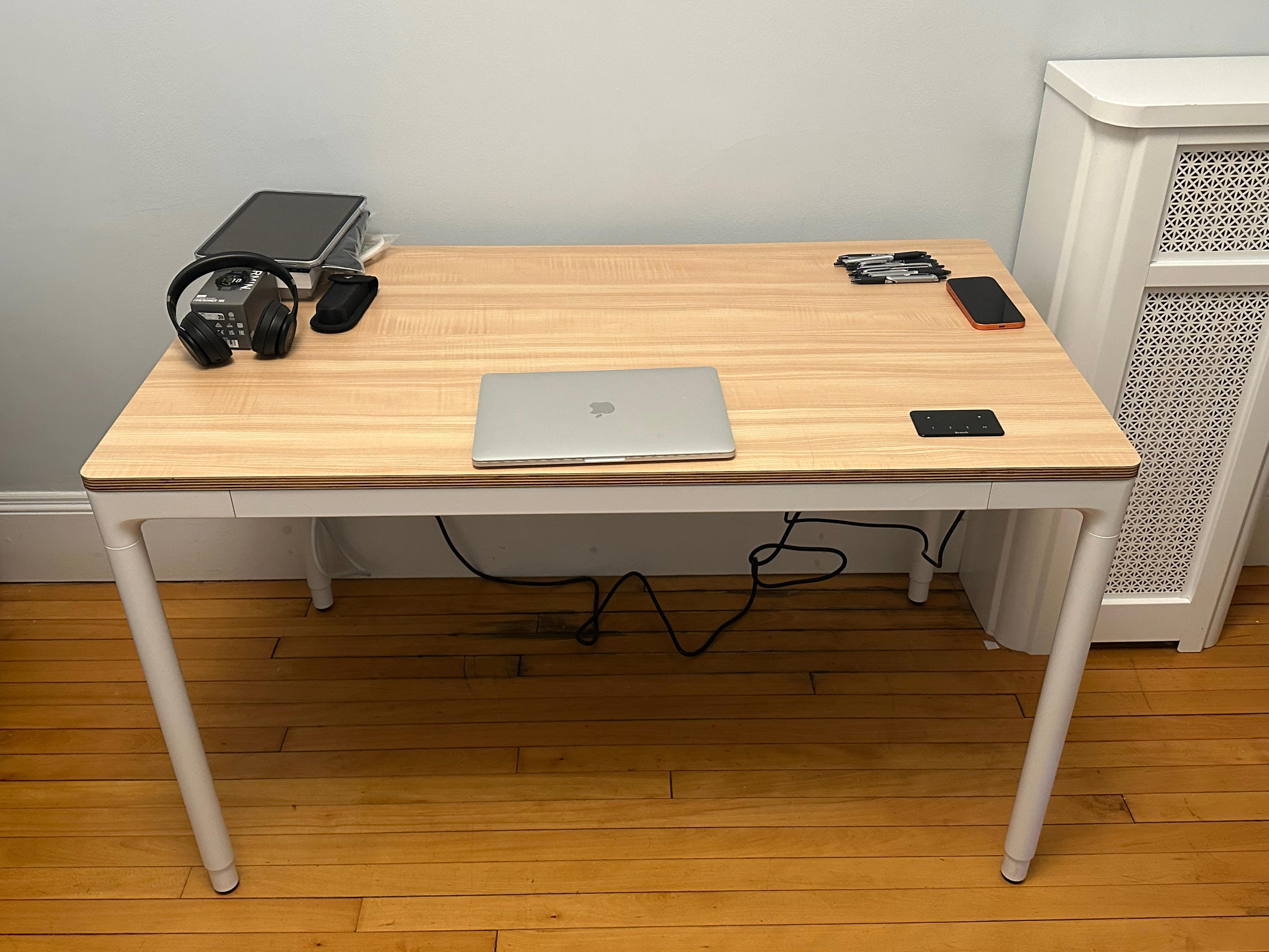 four leg standing desk with a laptop in the middle