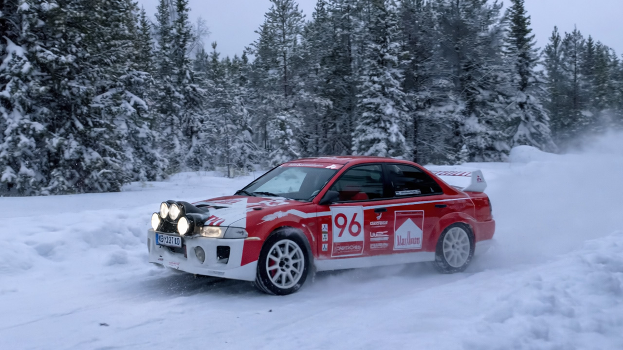 Mitsubishi EVO rally car sliding through snow