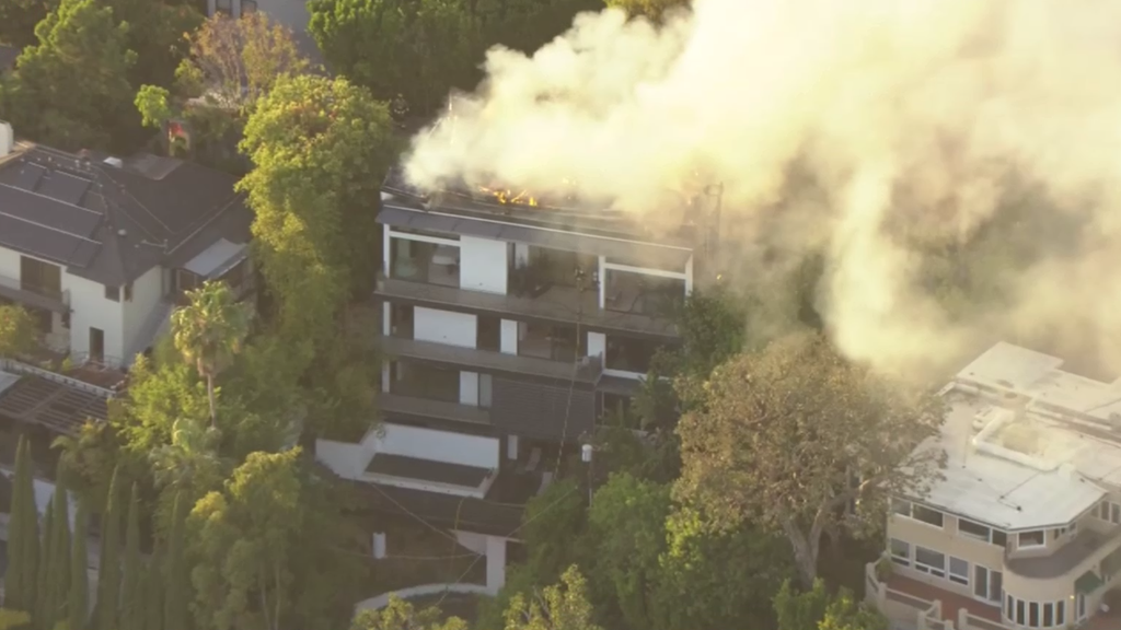 Los Angeles firefighters extinguish large fire at Hollywood Hills home