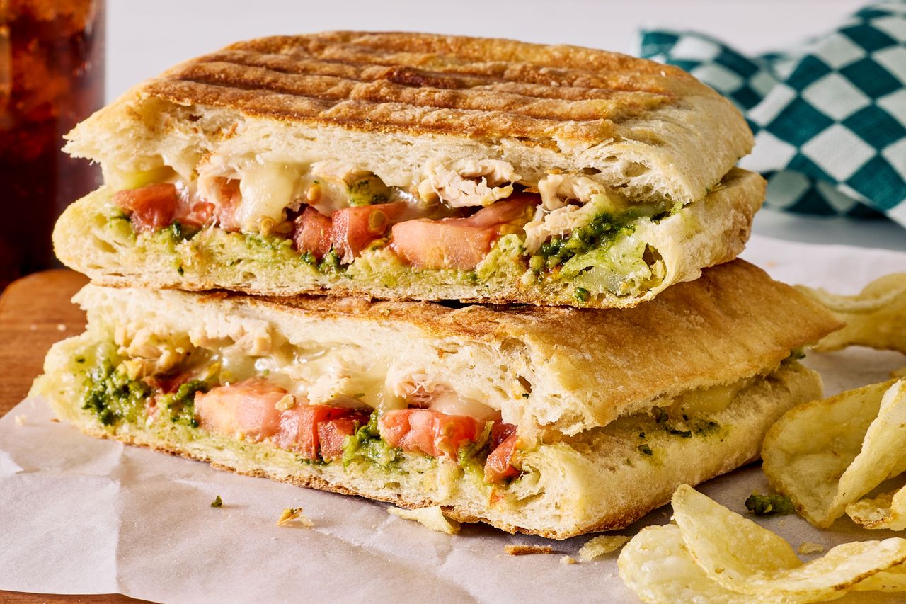 chicken fontina panini halves stacked on top of one another