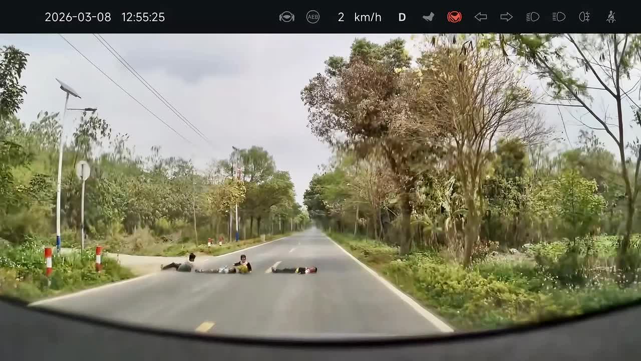 Children lying in road narrowly avoid being run over as car forcefully ...