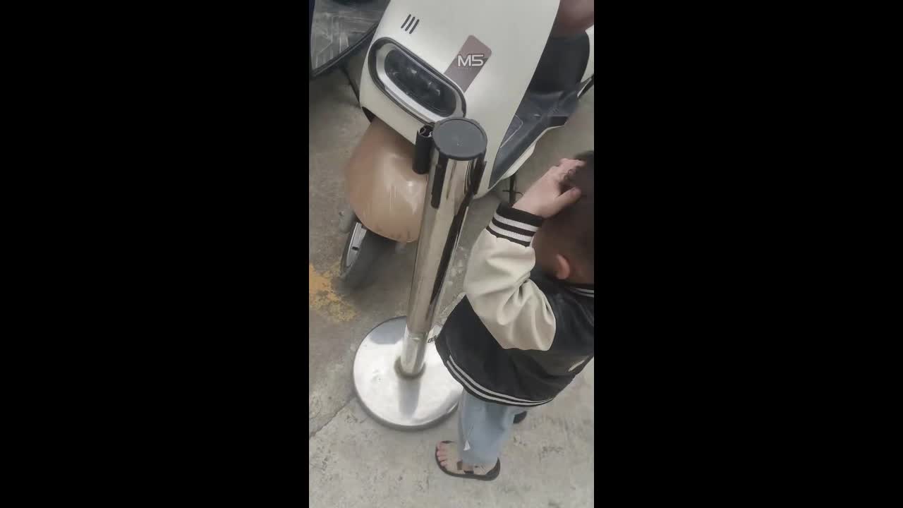 Boy gets playful with stanchion post in Guangdong, China