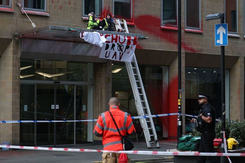 Three arrests after protesters cover Manchester building in red paint