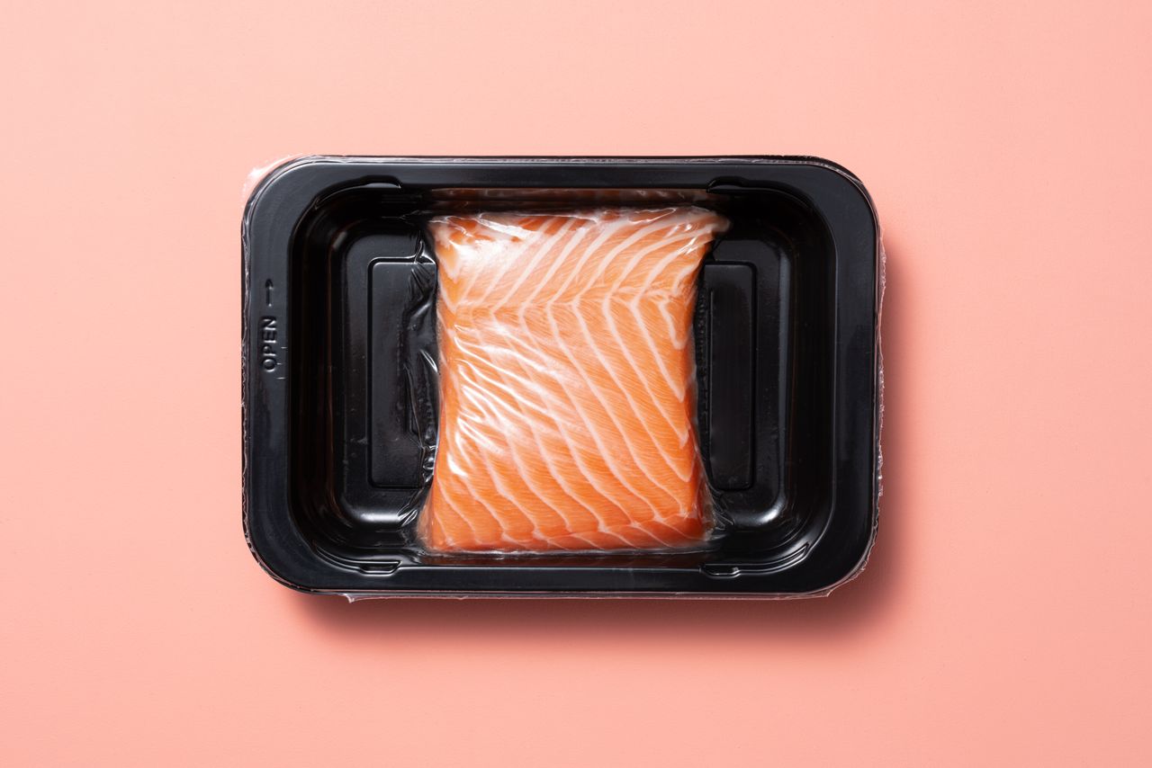 Vacuum Packed Atlantic Salmon Belly in a Black Plastic Tray.