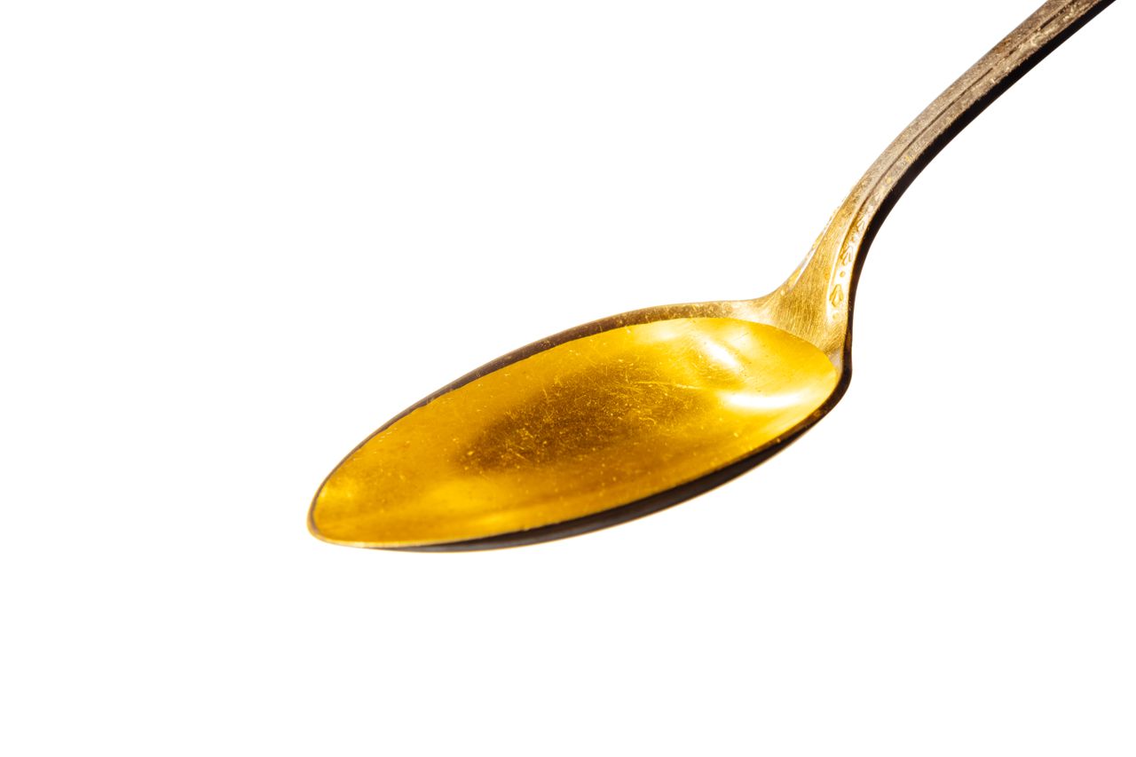 A spoon holding honey