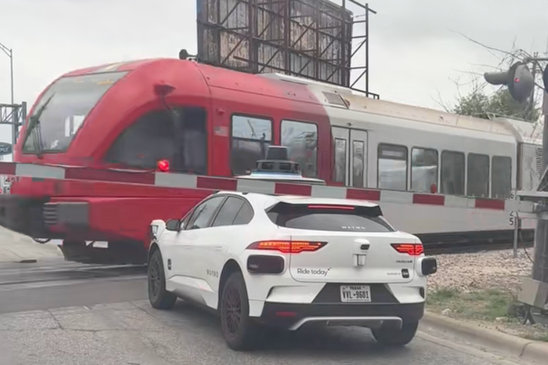 Terrifying moment Waymo stops inches away from passing train