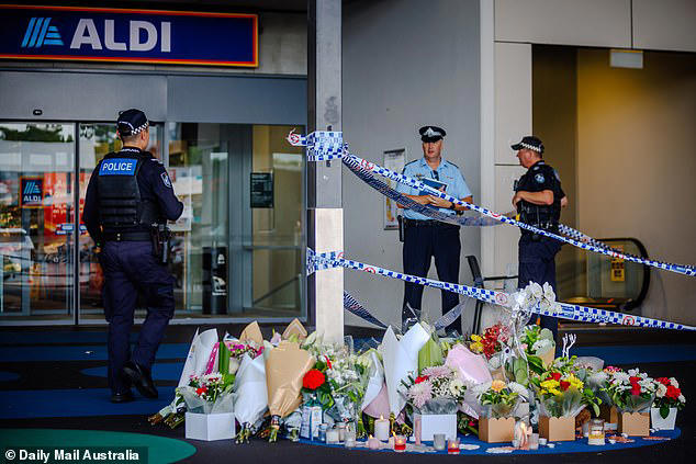 The teen demanded the grandmother's car keys before inflicting a 'non survivable' 17cm deep knife wound. Pictured are police near the crime scene