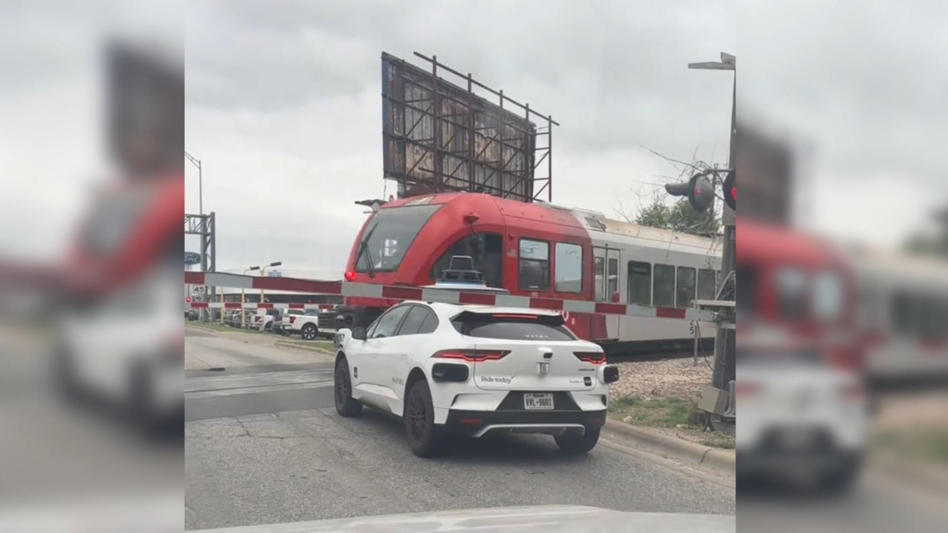 Video shows Waymo vehicle stopped inside railroad crossing as train passes