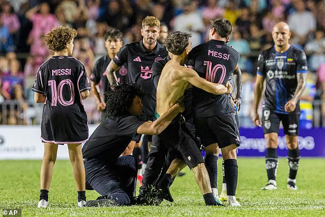 Lionel Messi hauled to ground by clumsy security guard after crazed fan ...