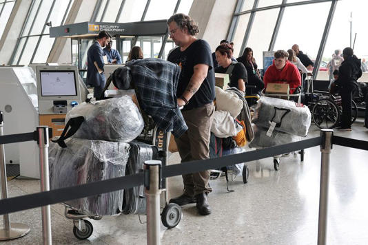 People from the first group of white South Africans granted refugee status for being deemed victims of racial discrimination under U.S. President Trump's Refugee plan, check in for a connecting flight, at Dulles International Airport, in Dulles, Virginia, U.S., May 12, 2025. REUTERS/Jonathan Ernst