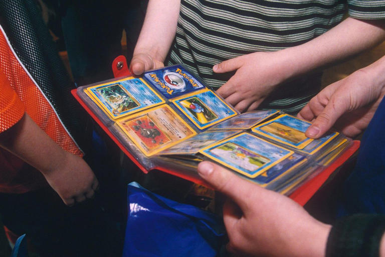 People look at a binder of Pokémon cards Credit: Ray Tang/Shutterstock
