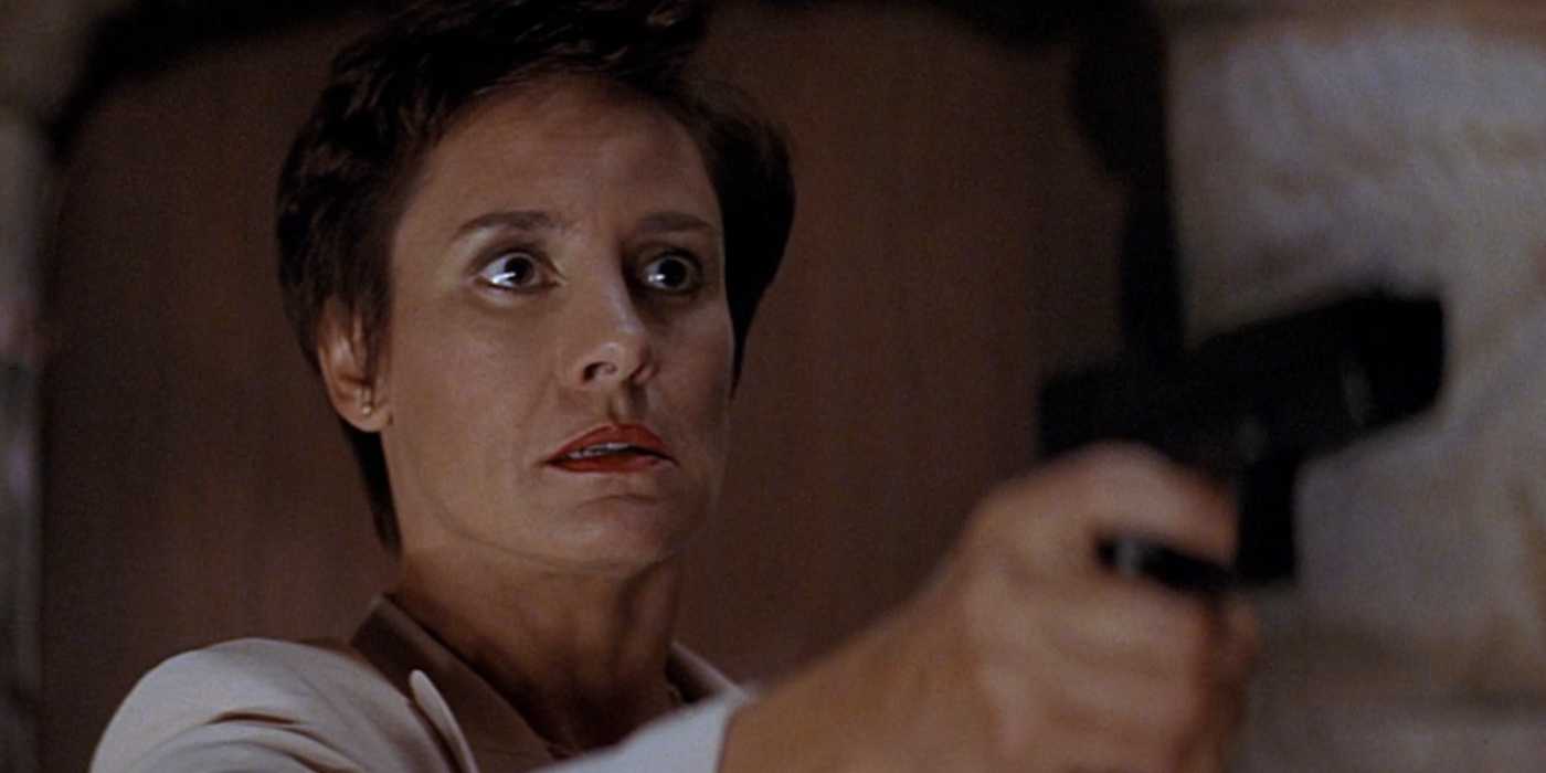 Laurie Metcalf as Nancy Loomis aiming a gun in Scream 2