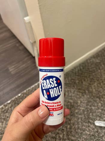 Hand holding a container of