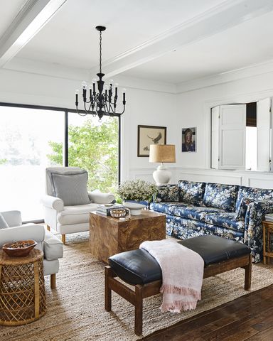 living room with floral sofa and burl wood coffee table