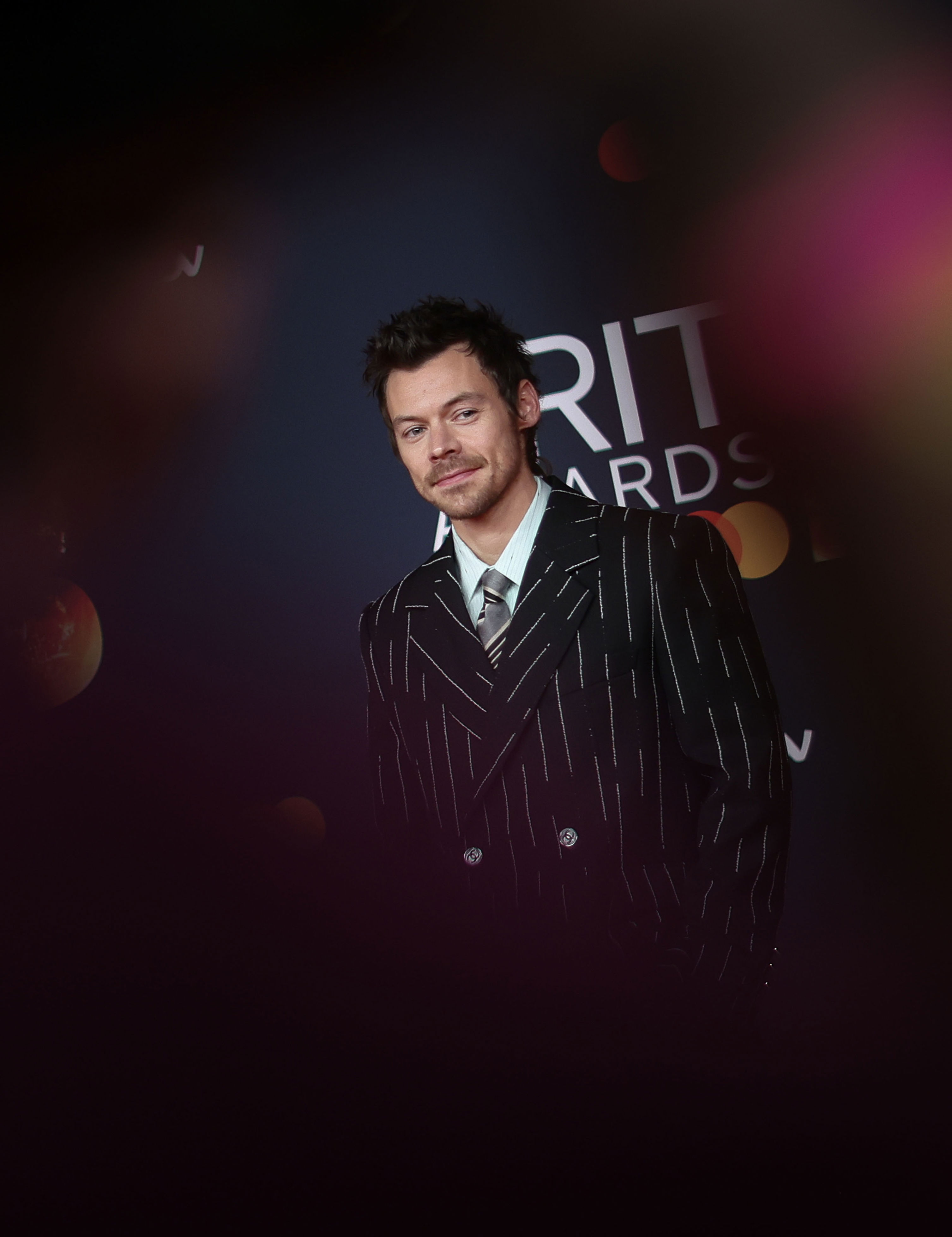 Harry Styles suits up in Chanel stripes and ballet flats at Brit Awards ...